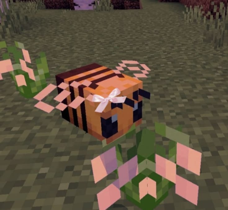 Minecraft bee sitting near small flowers in a cozy world